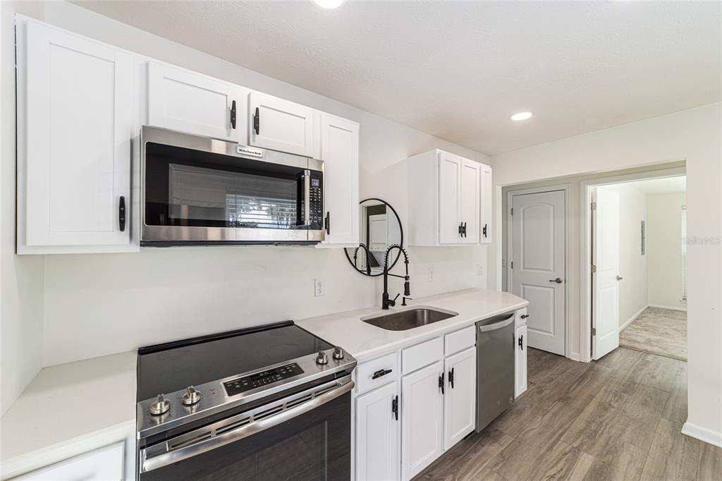 10399 Northeast 218th Lane Road Fort McCoy, FL 32134 - Photo 46 of 68 a kitchen with a stove and a microwave