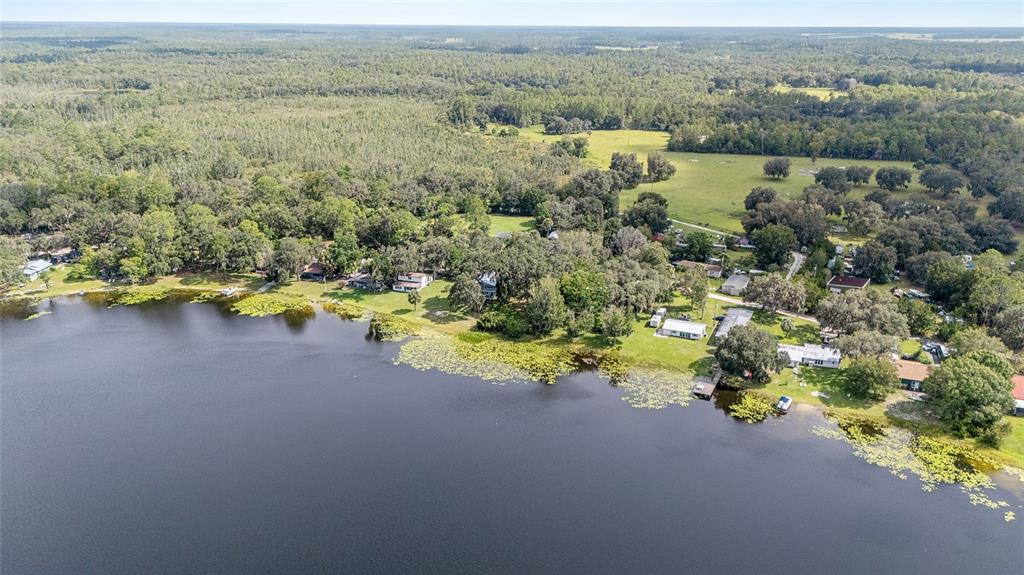 10399 Northeast 218th Lane Road Fort McCoy, FL 32134 - Photo 62 of 68 an aerial view of residential houses with outdoor space and ocean view