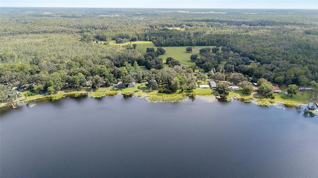 10399 Northeast 218th Lane Road Fort McCoy, FL 32134 - Photo 63 of 68 an aerial view of a house with a lake view
