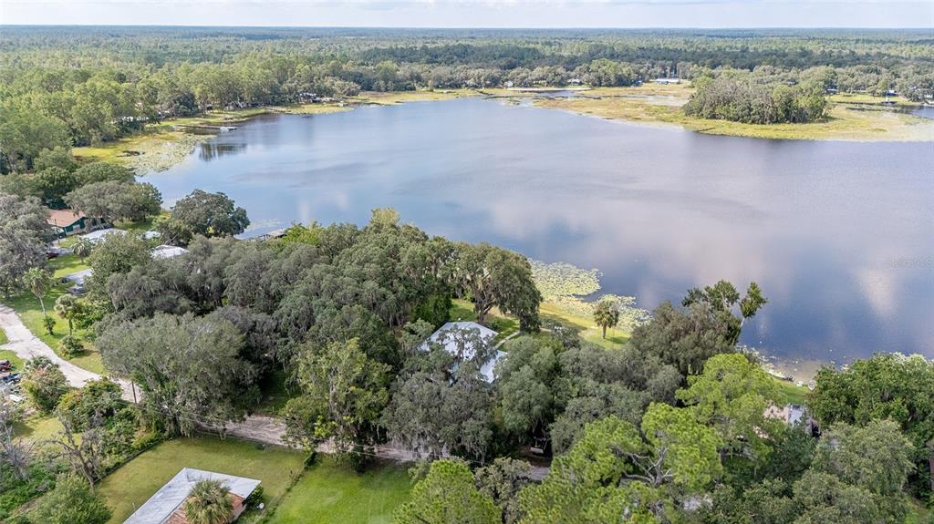 10399 Northeast 218th Lane Road Fort McCoy, FL 32134 - Photo 68 of 68 an aerial view of residential houses with outdoor space and lake view