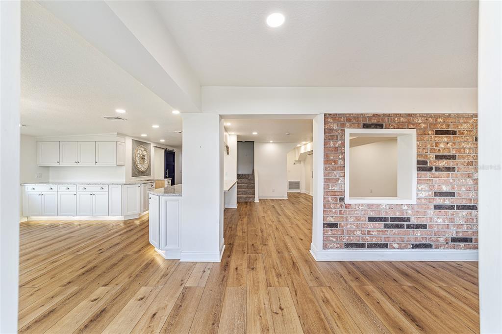 10399 Northeast 218th Lane Road Fort McCoy, FL 32134 - Photo 9 of 68 a view of a living room with kitchen island granite countertop wooden floor and a sink