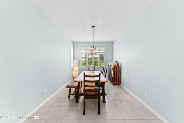 a dining room with furniture and a window