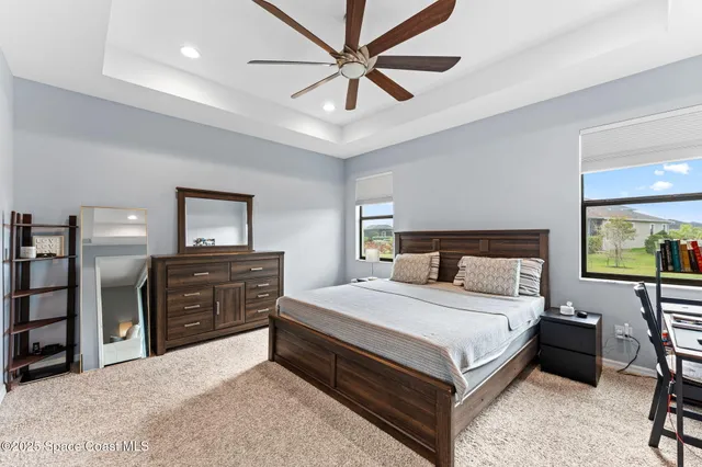 a bedroom with a large bed and a chandelier