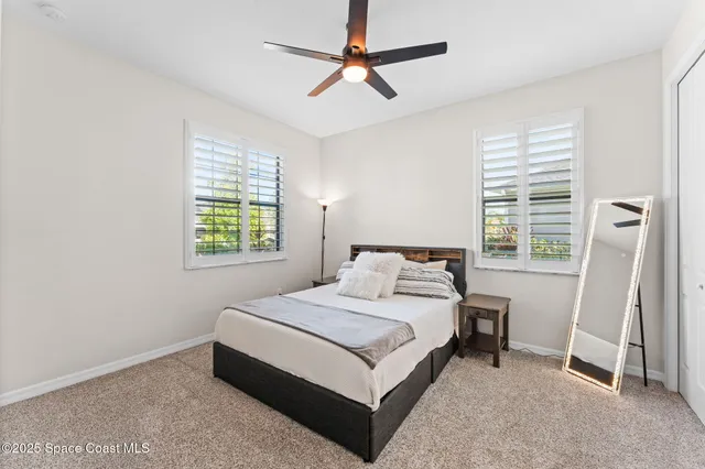 a bedroom with a bed next to a window