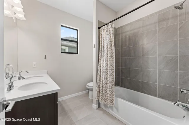 a bathroom with a sink mirror toilet and bathtub