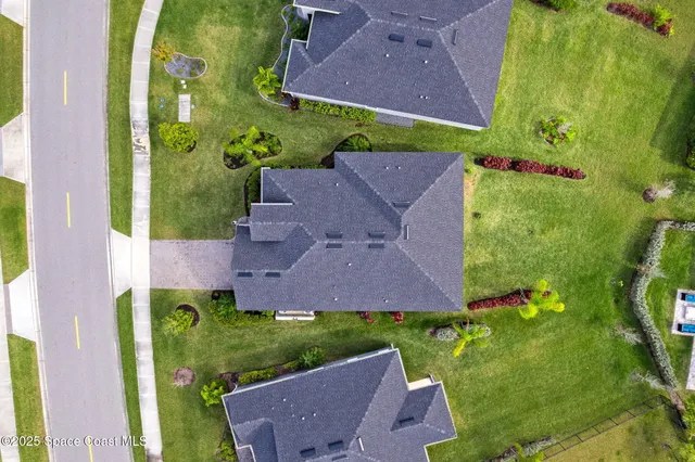 an aerial view of multiple houses with yard