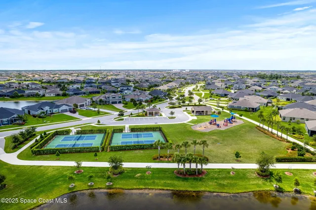 an aerial view of a house with a swimming pool yard and outdoor seating