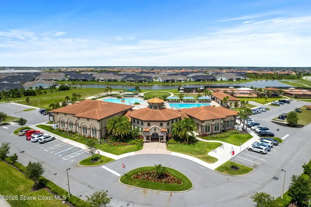 an aerial view of a residential houses with outdoor space