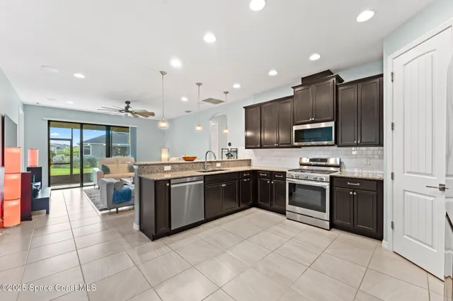 a large kitchen with stainless steel appliances lots of counter top space