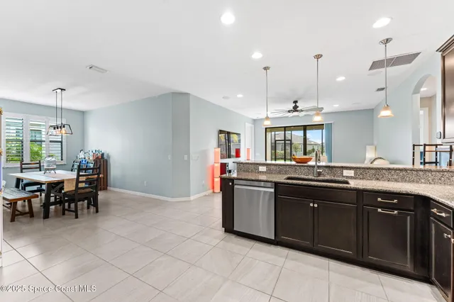 a large kitchen with kitchen island a sink and a island