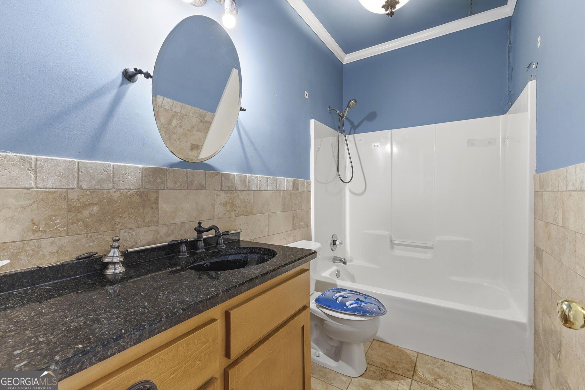 1469 Chestnut Street Macon, GA 31201 - Photo 13 of 26 a bathroom with a granite countertop sink a toilet and bathtub