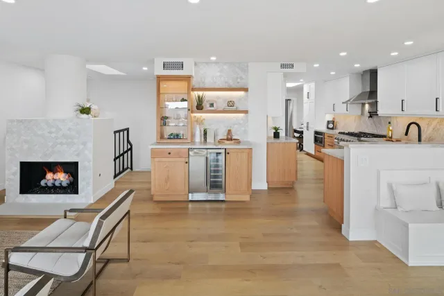 a large kitchen with cabinets table and chairs