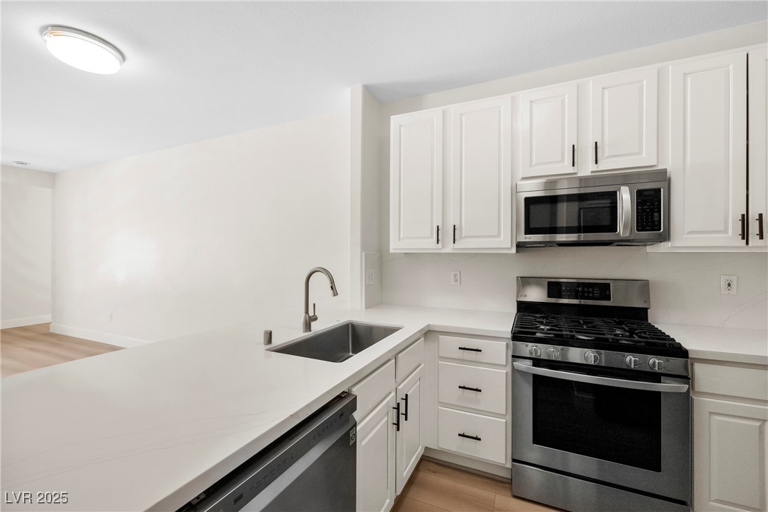 7139 South Durango Drive, Unit 203 Las Vegas, NV 89113 - Photo 12 of 25 Kitchen with appliances with stainless steel finishes, and white cabinetry