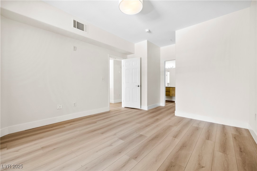7139 South Durango Drive, Unit 203 Las Vegas, NV 89113 - Photo 15 of 25 Bedroom with brand new light flooring and baseboards