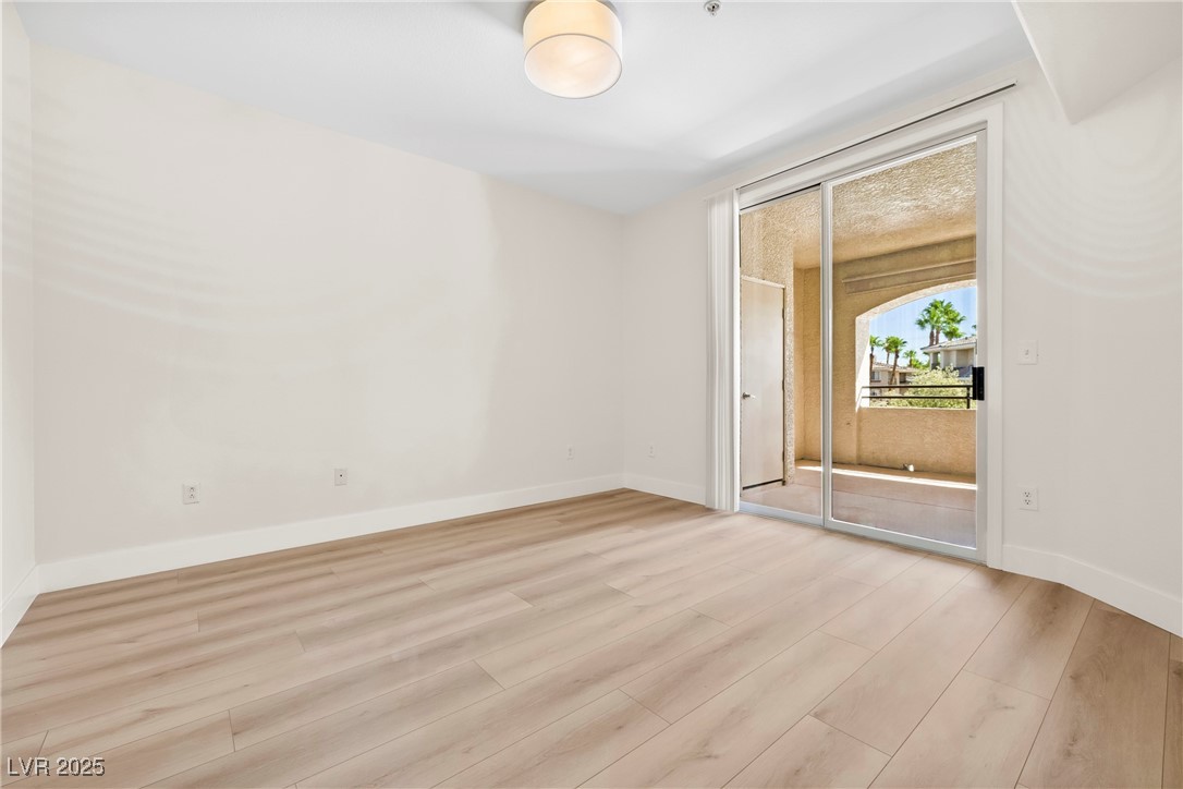 7139 South Durango Drive, Unit 203 Las Vegas, NV 89113 - Photo 16 of 25 Bedroom new flooring and with baseboards. Patio View