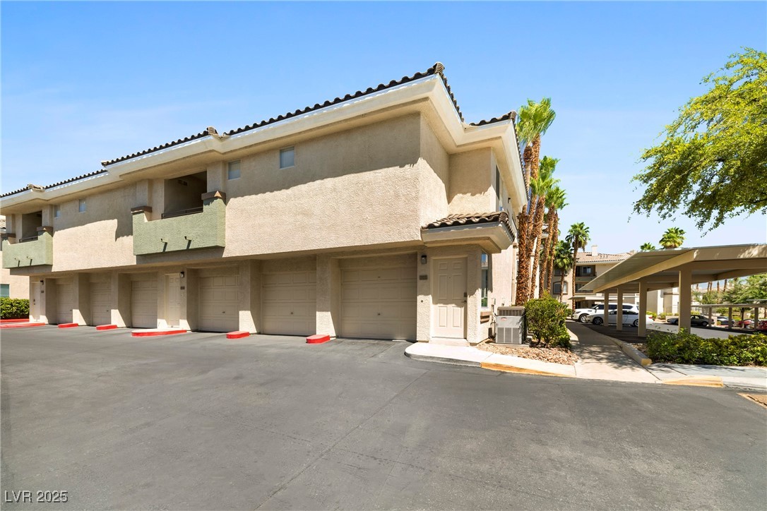 7139 South Durango Drive, Unit 203 Las Vegas, NV 89113 - Photo 2 of 25 View of property featuring attatched garage