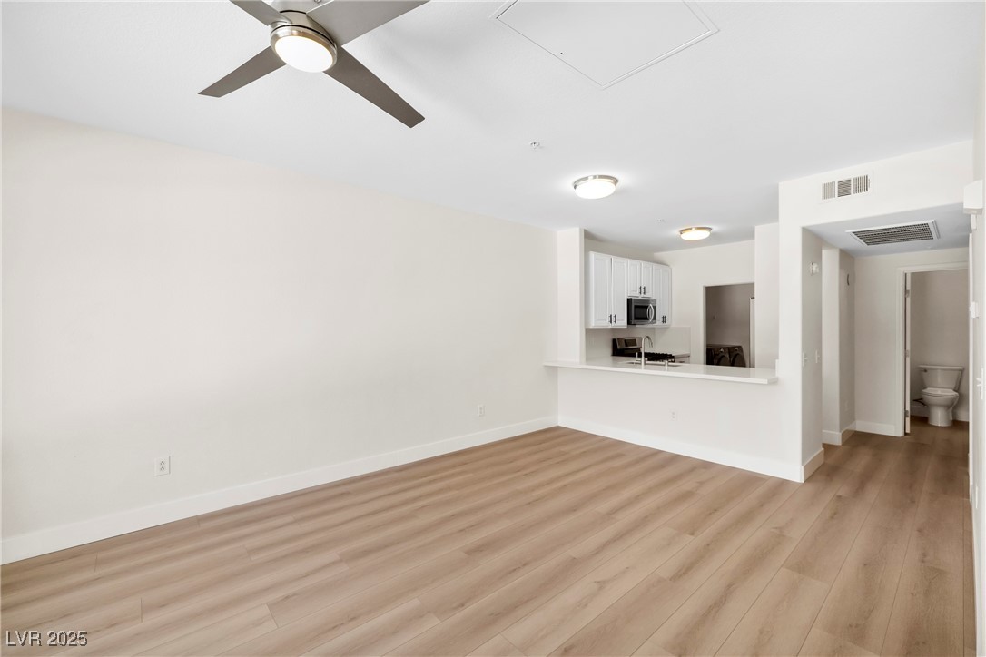 7139 South Durango Drive, Unit 203 Las Vegas, NV 89113 - Photo 9 of 25 living room with light wood finished floors and ceiling fan