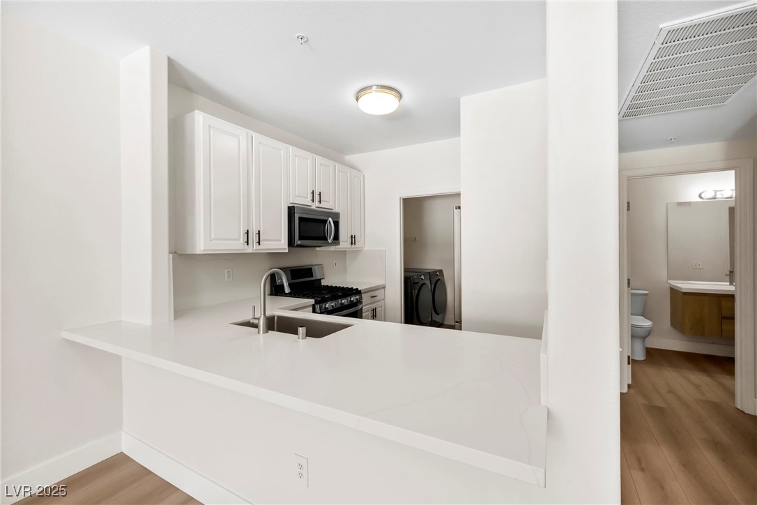 7139 South Durango Drive, Unit 203 Las Vegas, NV 89113 - Photo 10 of 25 Kitchen with white cabinetry,Brand new countertop, Brand new sink and faucet
