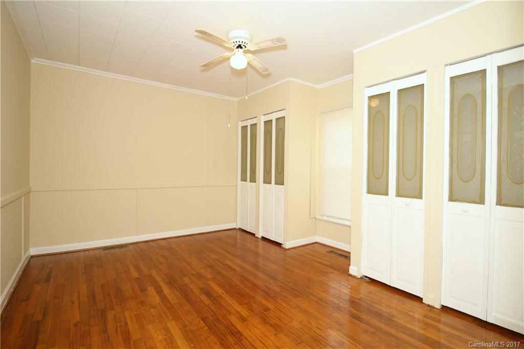 1104 Brantley Road Kannapolis, NC 28083 - Photo 12 of 14 an empty room with wooden floor and a ceiling fan