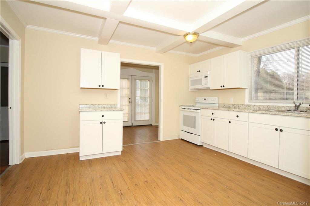 1104 Brantley Road Kannapolis, NC 28083 - Photo 5 of 14 a kitchen with granite countertop a sink cabinets and wooden floor