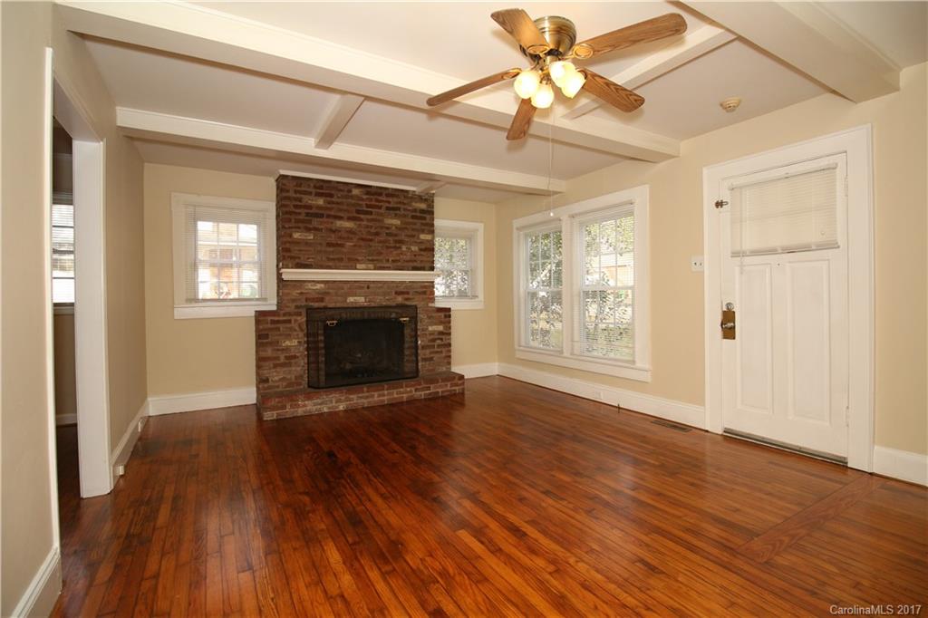 1104 Brantley Road Kannapolis, NC 28083 - Photo 8 of 14 a view of an empty room with wooden floor fireplace and a window
