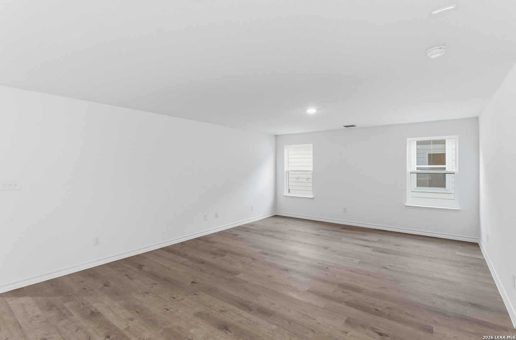 4057 Bermuda Lane Seguin, TX 78155 - Photo 14 of 30 an empty room with wooden floor and windows