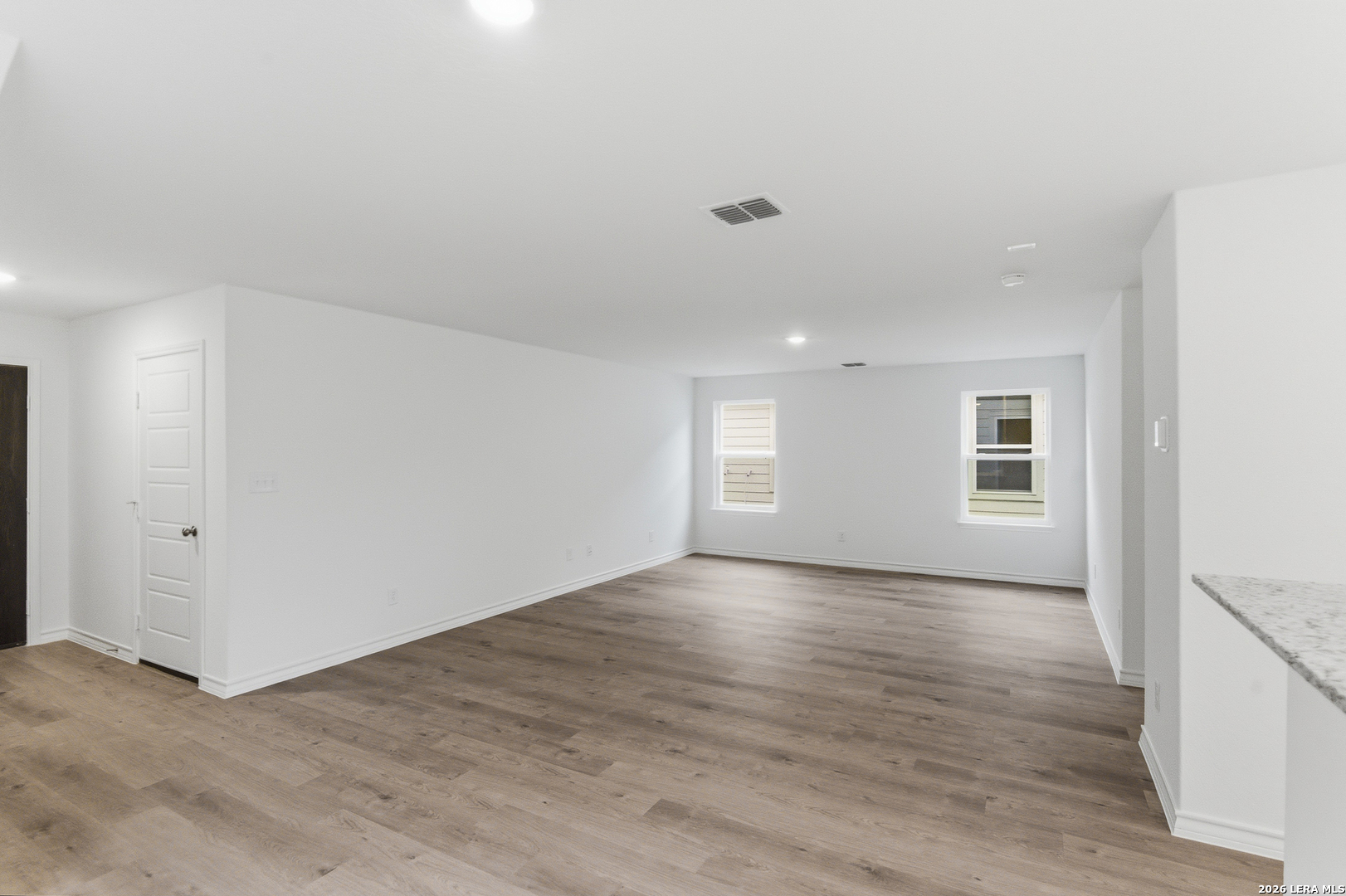 4057 Bermuda Lane Seguin, TX 78155 - Photo 2 of 30 a view of an empty room with wooden floor and a window