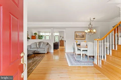 a living room with furniture potted plant and a window