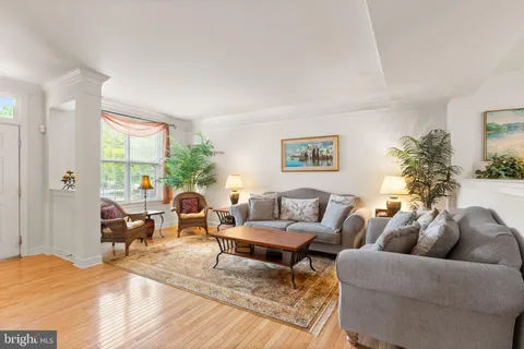 a view of a dining room with furniture wooden floor and a chandelier