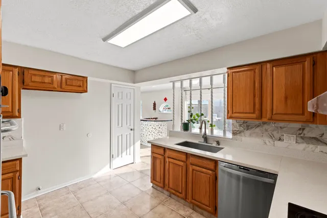 a kitchen with stainless steel appliances granite countertop a sink and cabinets
