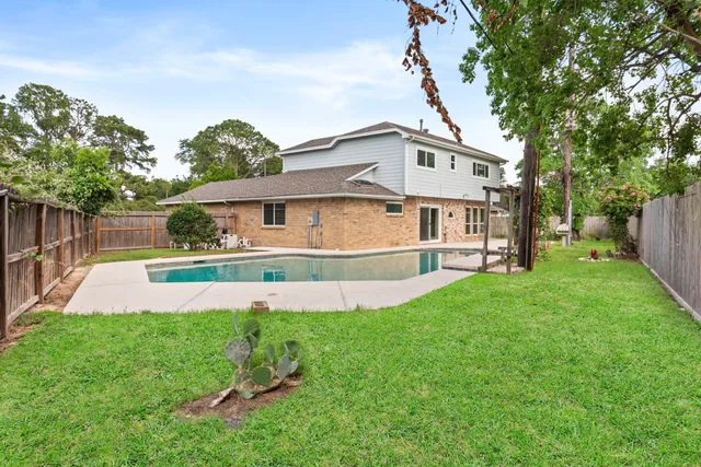 a view of a house with a yard and sitting area