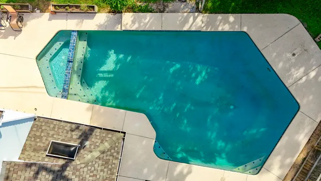an aerial view of a house with a swimming pool