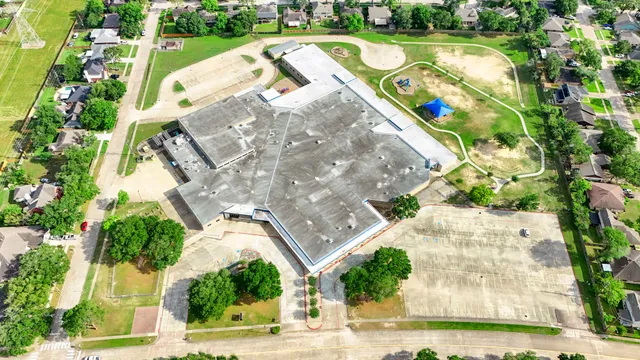 an aerial view of a house with a yard and outdoor seating