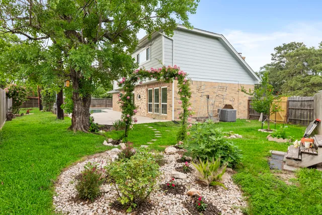 a front view of house with a garden
