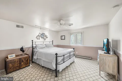 a bathroom with a sink a toilet and shower curtain