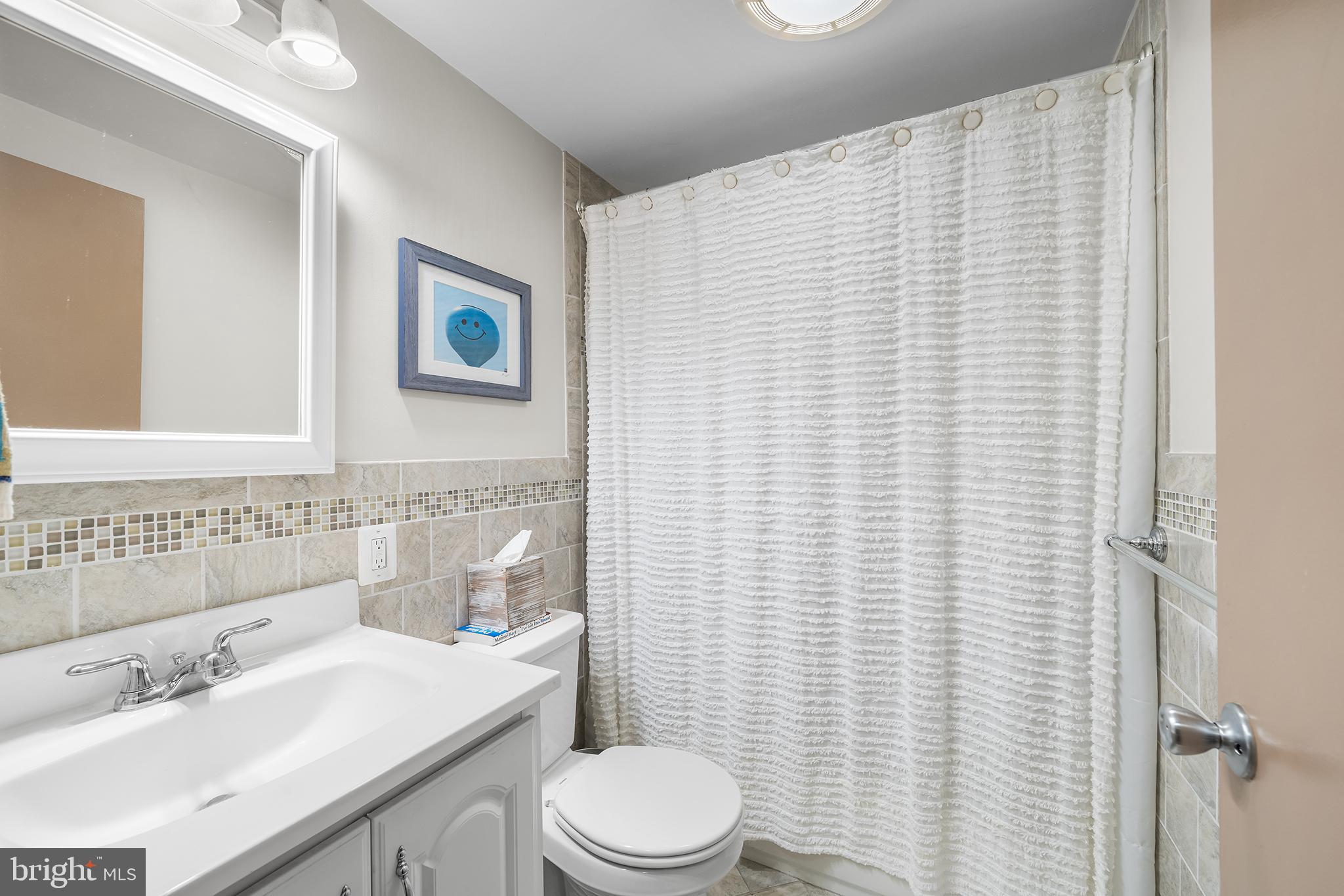 190 Pine Tree Road King of Prussia, PA 19406 - Photo 20 of 37 a bathroom with a sink a toilet and shower curtain