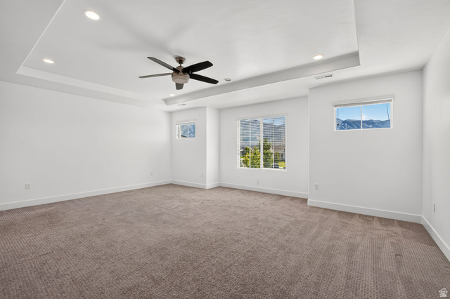 6536 West Muirfield Road Highland, UT 84003 - Photo 24 of 48 Spacious room featuring a tray ceiling with recessed lighting and a ceiling fan