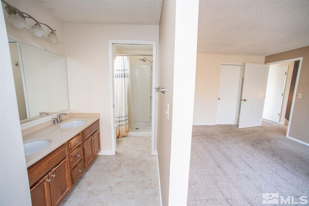 2730 Powder Drive Reno, NV 89503 - Photo 9 of 30 a spacious bathroom with a double vanity sink a mirror and a shower
