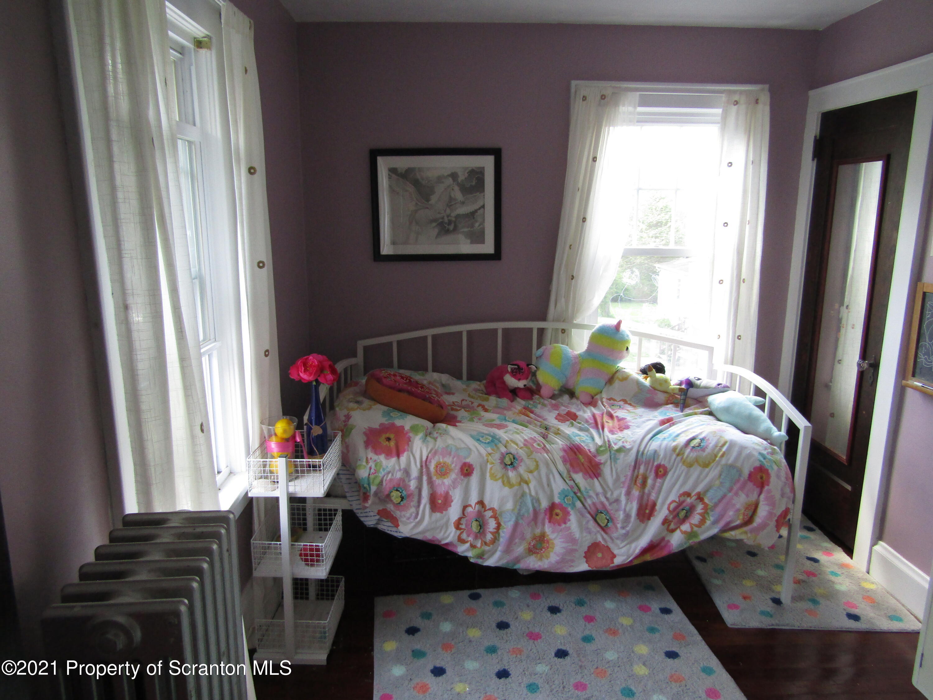 1314 State Rte 435 Moscow, PA 18444 - Photo 25 of 27 a bedroom with a bed and wooden floor