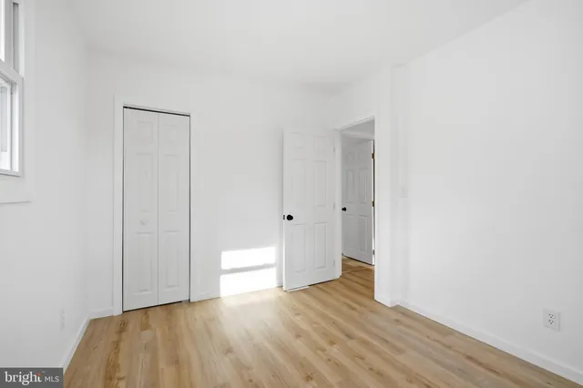 a view of an empty room and wooden floor