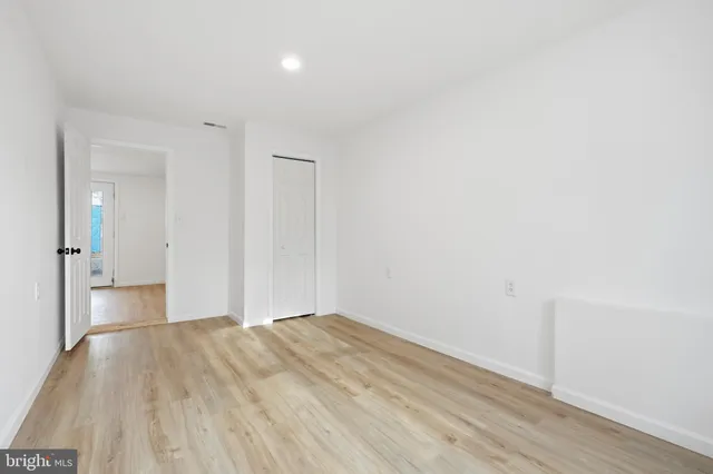 a view of hallway with wooden floor