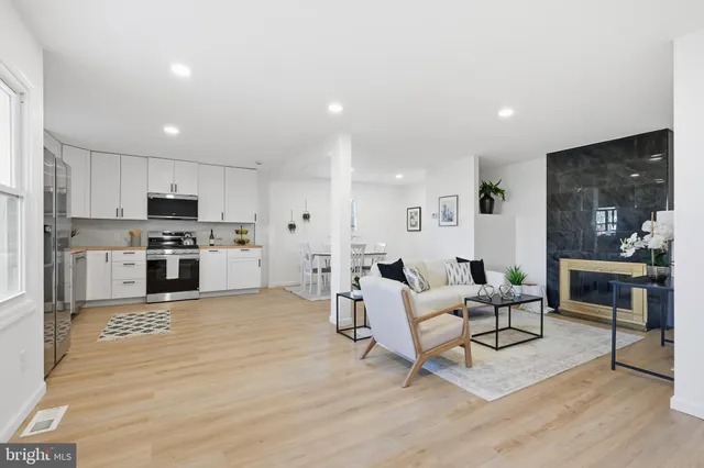 a living room with furniture and kitchen view