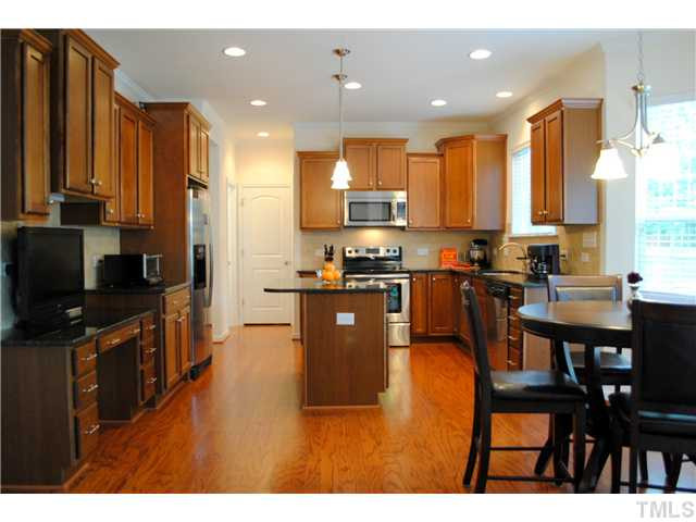 1018 Lakeview Road Durham, NC 27712 - Photo 2 of 25 a kitchen with stainless steel appliances granite countertop a stove a sink a microwave a dining table and chairs