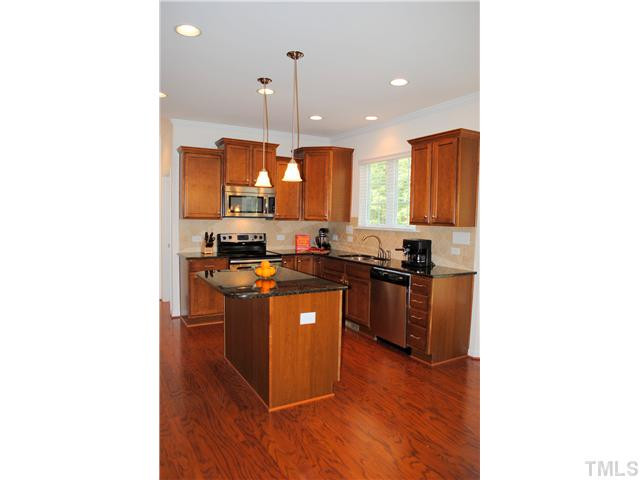 1018 Lakeview Road Durham, NC 27712 - Photo 5 of 25 a kitchen with stainless steel appliances granite countertop a sink a stove and a refrigerator