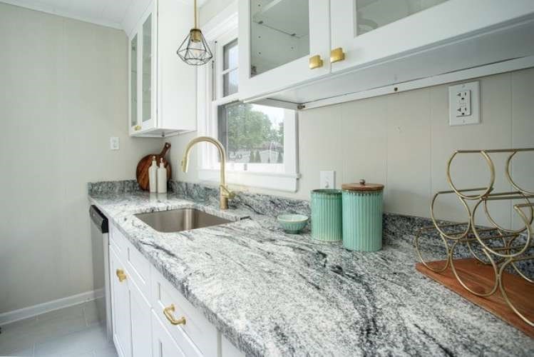 175 Maple Street Somerset, MA 02726 - Photo 4 of 25 a kitchen with a sink a stove and cabinets