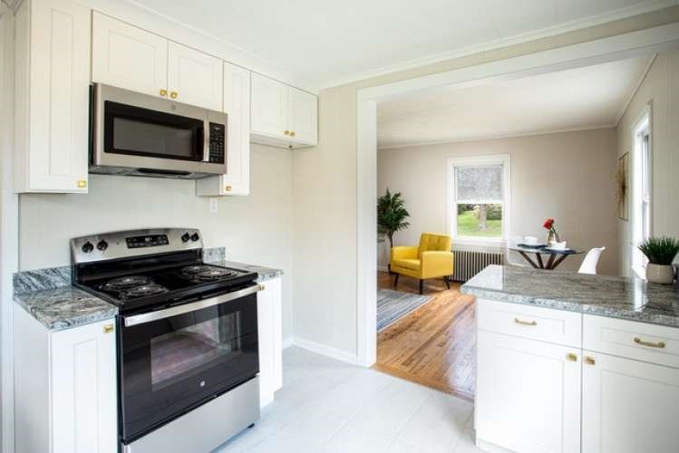 175 Maple Street Somerset, MA 02726 - Photo 6 of 25 a kitchen with a stove and a microwave