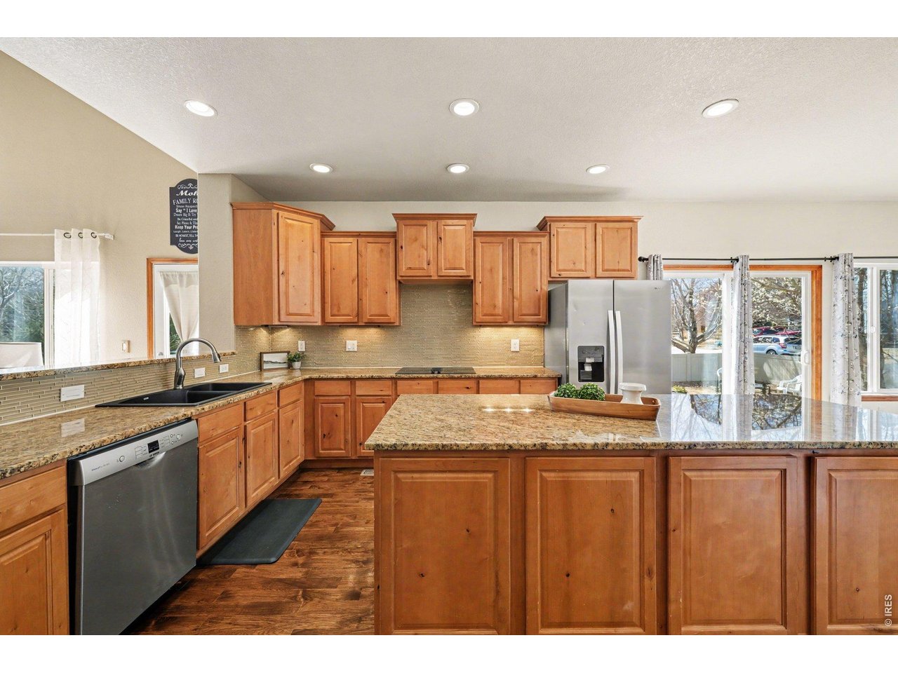 5507 Morgan Way Frederick, CO 80504 - Photo 15 of 45 a kitchen with stainless steel appliances granite countertop sink stove and large window