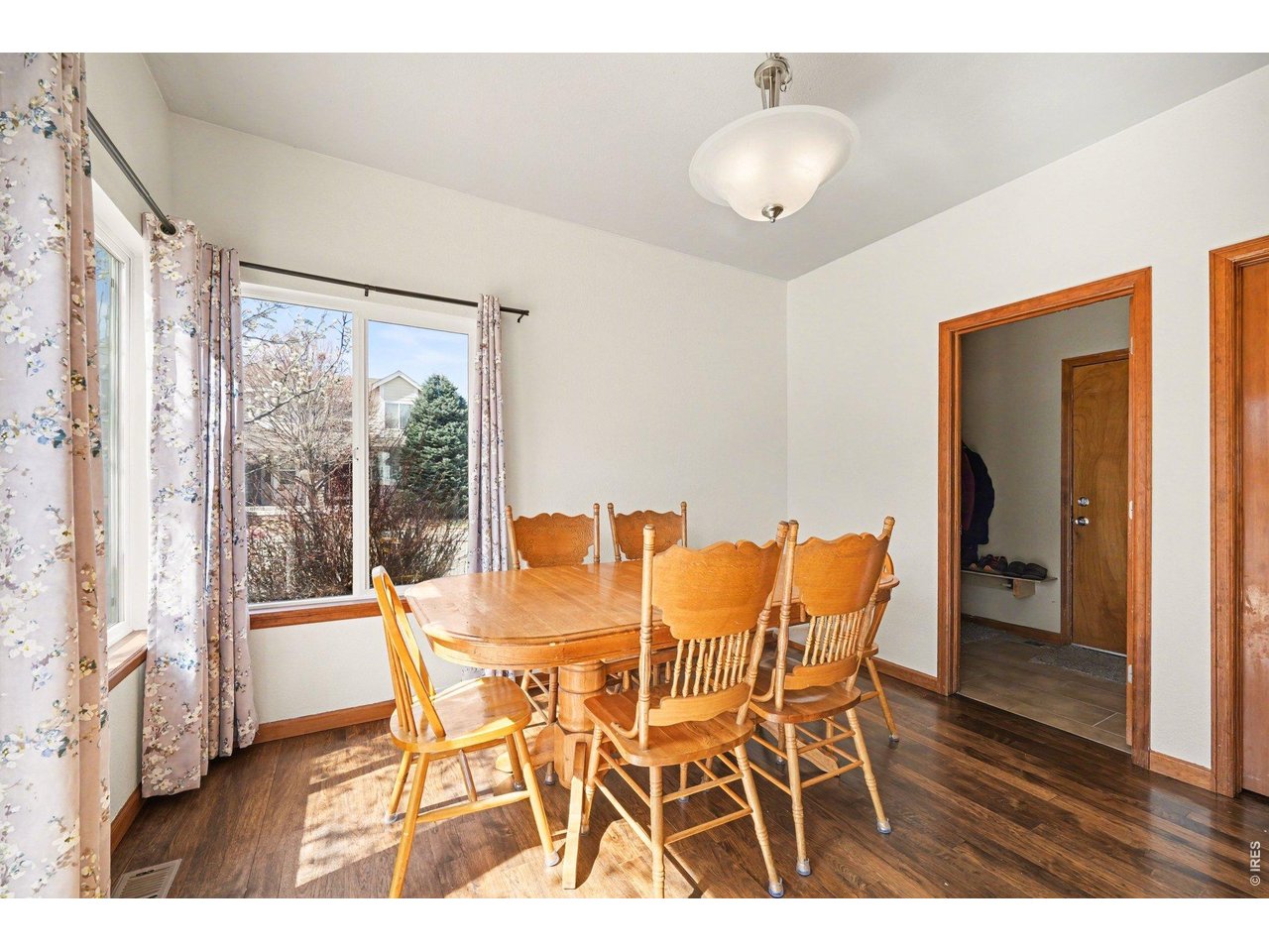 5507 Morgan Way Frederick, CO 80504 - Photo 19 of 45 a dining room with furniture and wooden floor