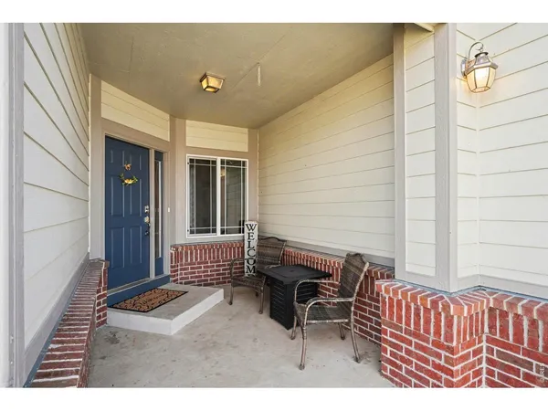 a balcony with a bench and chair