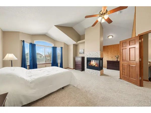 a large bedroom with a bed and a fireplace